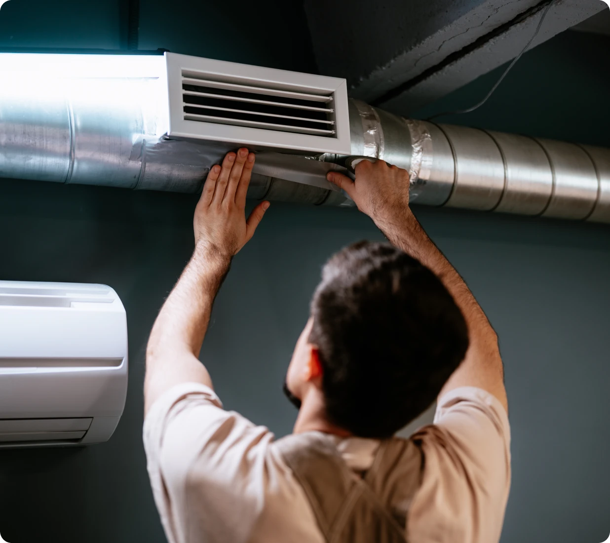 Technician fixing HVAC system
