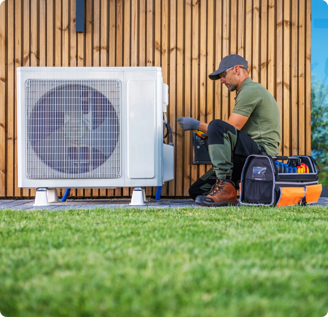 Worker fixing HVAC system outdoors